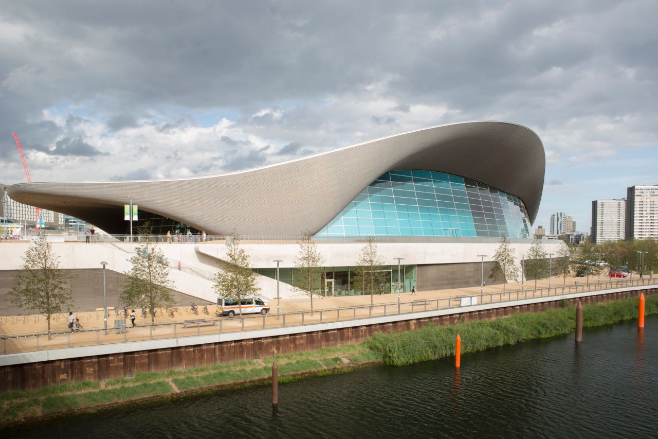 <a href="http://www.londonaquaticscentre.org/" target="_blank" target="_blank">The London Aquatics Centre</a>, designed by Zaha Hadid Architects, has a 11,200-square-foot steel roof in the shape of a wave. Two colossal glass walls maximumize natural light inside and offer views of the Olympic Park. 
