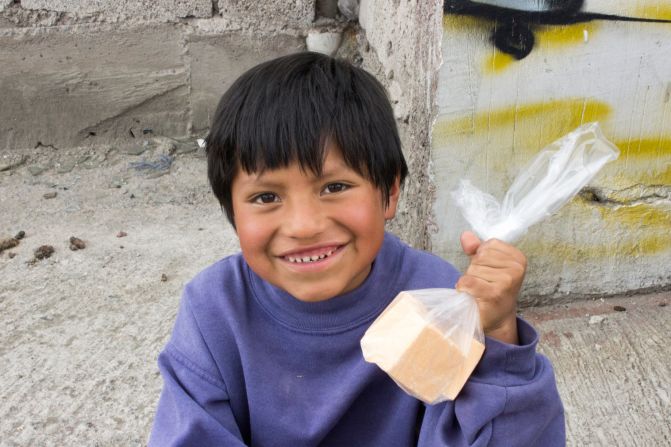 A young boy in Honduras shows off the soap Clean the World gave him during a distribution trip in 2012.