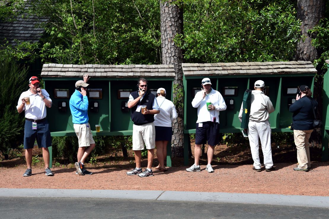 Patrons make phone calls during a practice round 