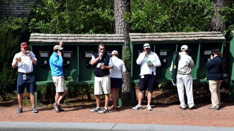 Patrons make phone calls during a practice round 