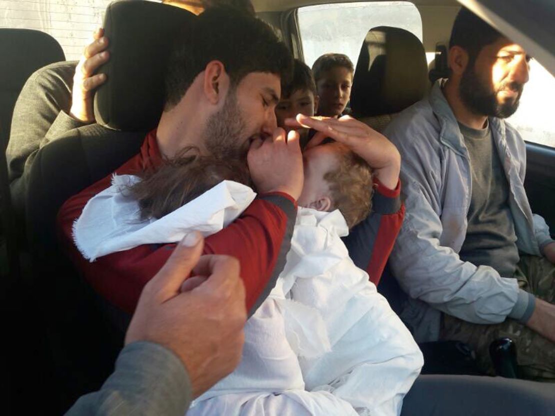 Youssef holds his twins, who were killed in Tuesday's chemical attack.
