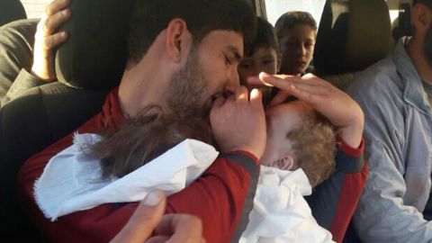 Youssef holds his twins, who were killed in Tuesday's chemical attack.
