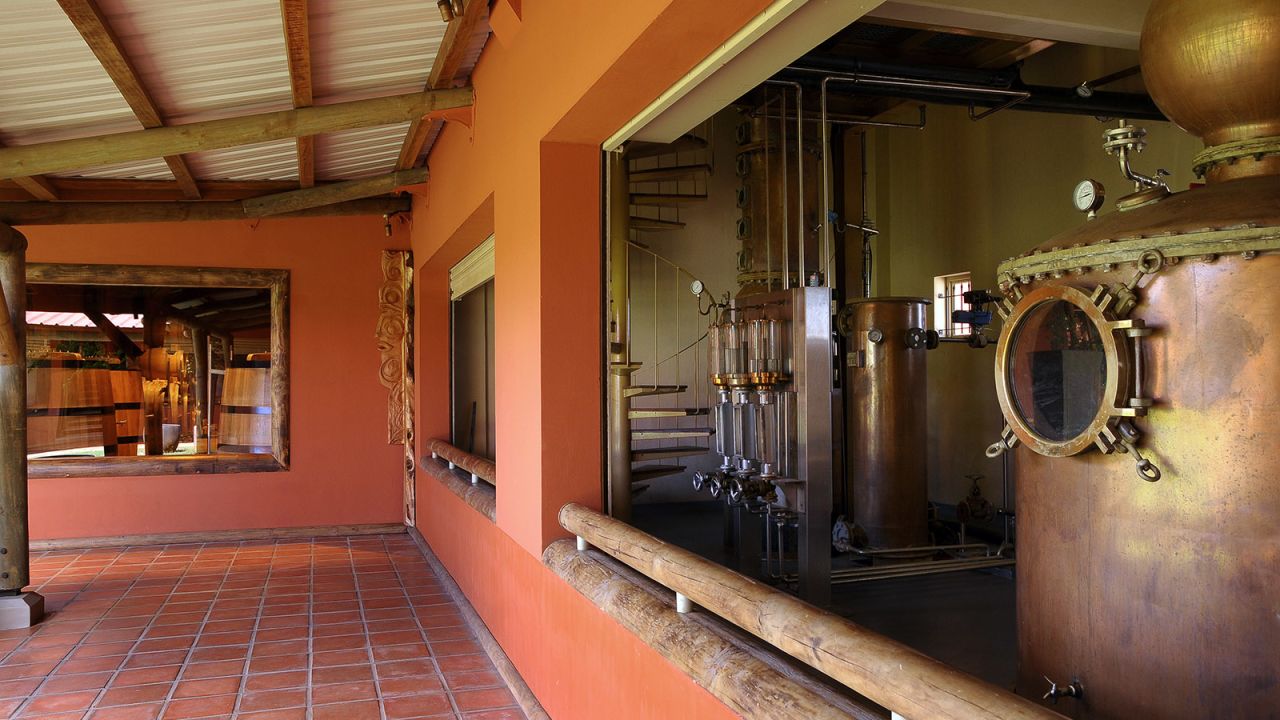 <strong>A time-sensitive process:</strong> The process of making agricole rum requires distilling the juice as quickly as possible after it's crushed out of the cane. That's why the heavy equipment is located in the middle of the plantation, with vats right next to the grinding machinery.