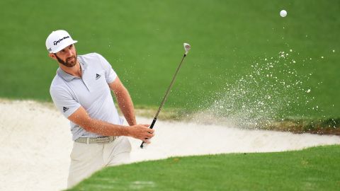 Dustin Johnson plays a shot from a bunker on the 10th hole during a practice round before the 2017 Masters Tournament at Augusta National Golf Club.