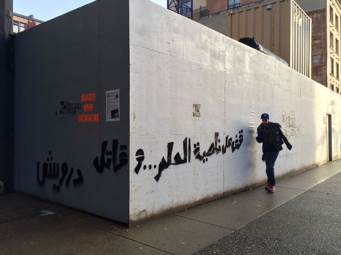 Shehab's street art includes writings from Palestinian poet Mahmoud Darwish: "Stand at the corner of a dream and fight"