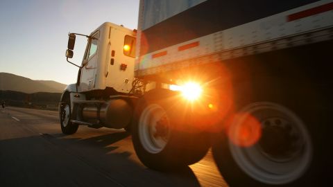 A truck travels the I-210 freeway at dawn near Fontana, California.