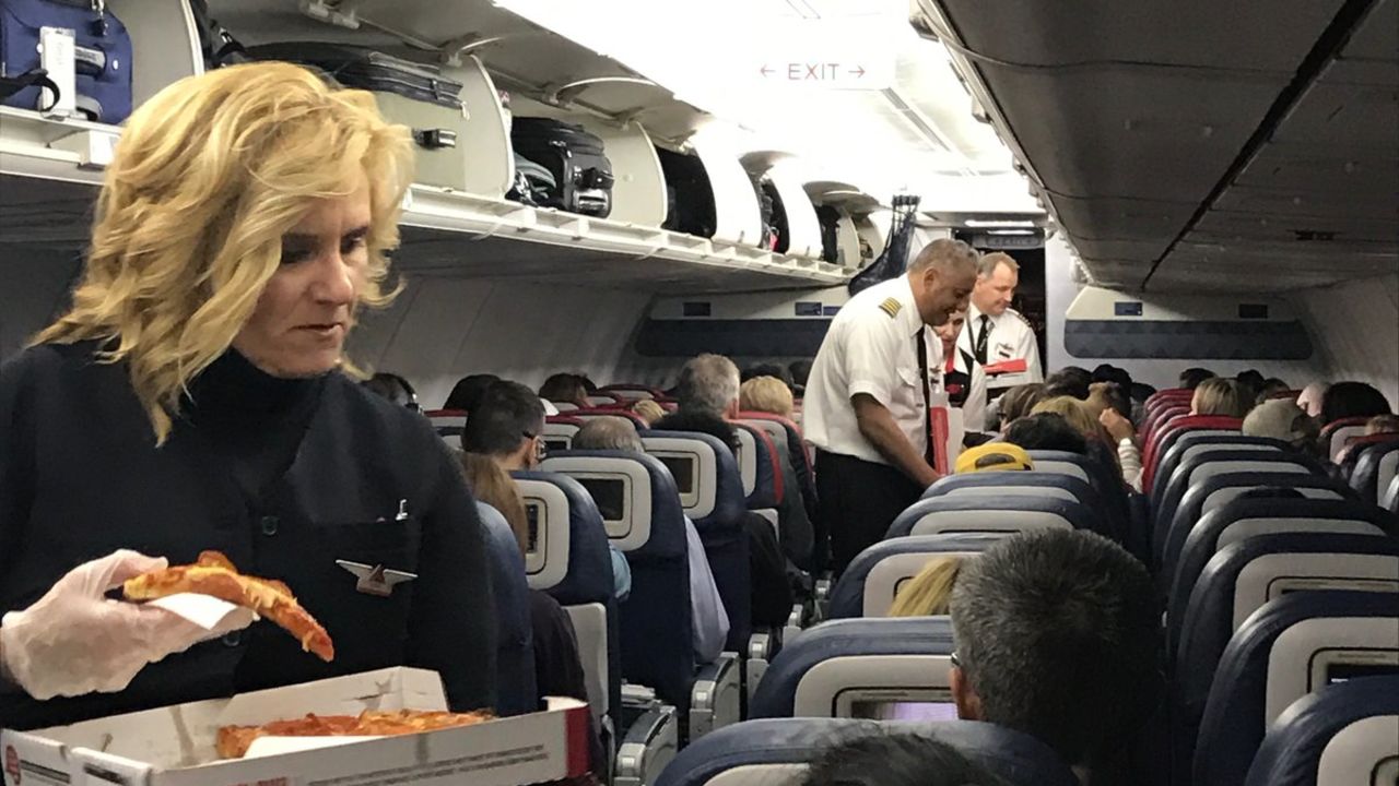 Crew members delivered pizza to stranded Delta customers Wednesday. 