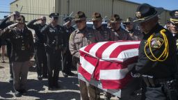 Officers from the Navajo Nation Police Department and the McKinley County Sheriff's Department carry the casket of fallen Navajo Nation Police Officer Houston Largo at Sunset Memorial Park in Gallup, N.M., Thursday, March 16, 2017. The 27-year-old decorated officer was shot while responding to a domestic violence call in remote New Mexico. (Cayla Nimmo/Gallup Independent via AP)