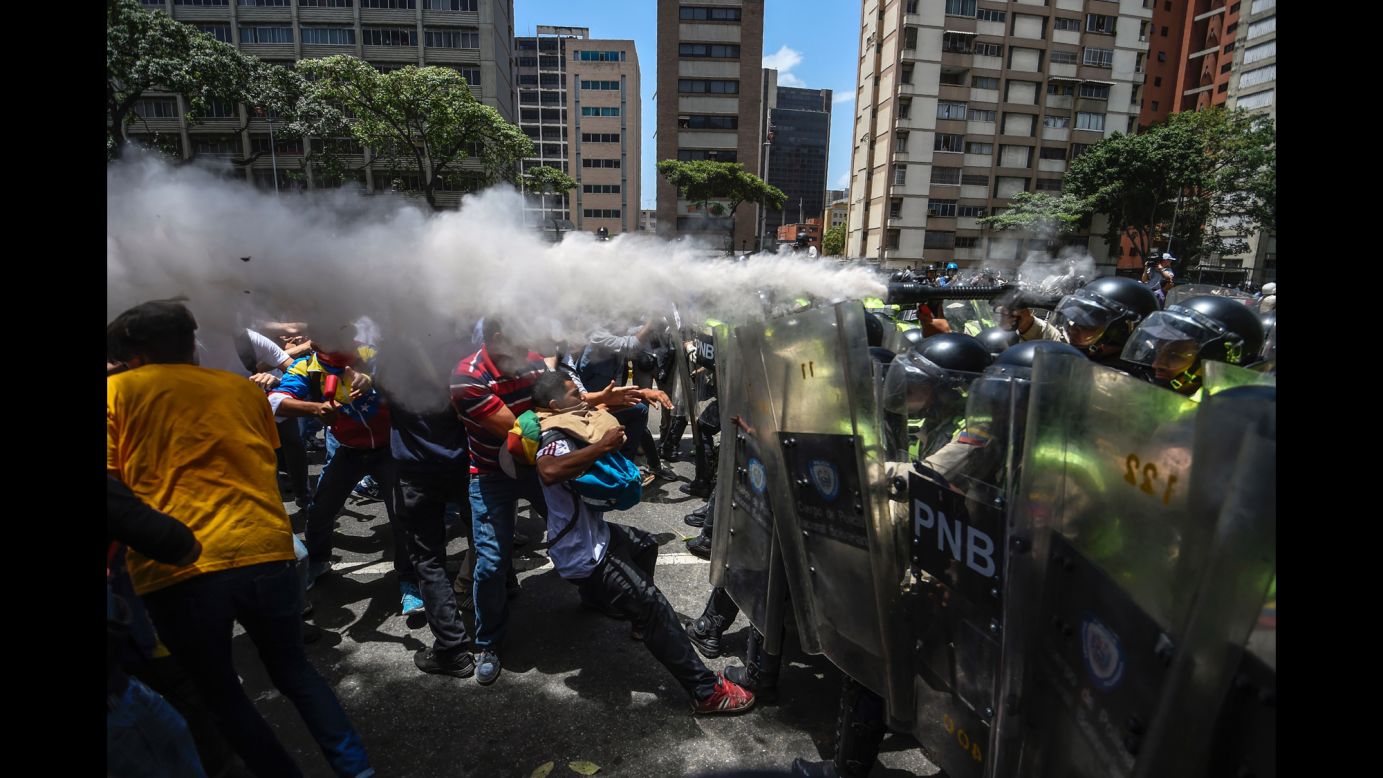 Opposition activists clash with police as they protest against the Venezuelan government in Caracas on Tuesday, April 4. Last week, the Venezuelan Supreme Court <a href="http://www.cnn.com/2017/03/30/americas/venezuela-dissolves-national-assembly/" target="_blank">stripped the country's National Assembly of its powers.</a> The National Assembly, Venezuela's legislative body, has had an opposition majority since January 2016.