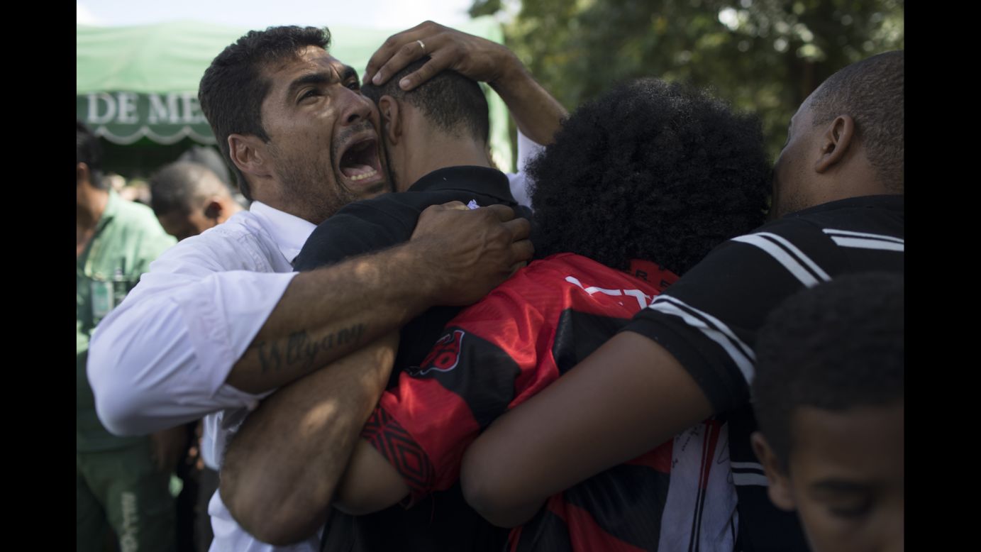 People cry Saturday, March 1, during the burial of Maria Eduarda Alves da Conceicao, a 13-year-old who was killed by a stray bullet during a shootout between police and alleged drug traffickers in Rio de Janeiro.