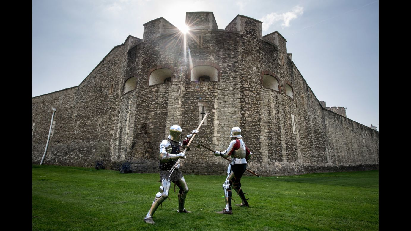 Historical interpreters Mark Griffin, left, and Tom Fermor demonstrate a poleax fight at the Tower of London on Thursday, April 6.