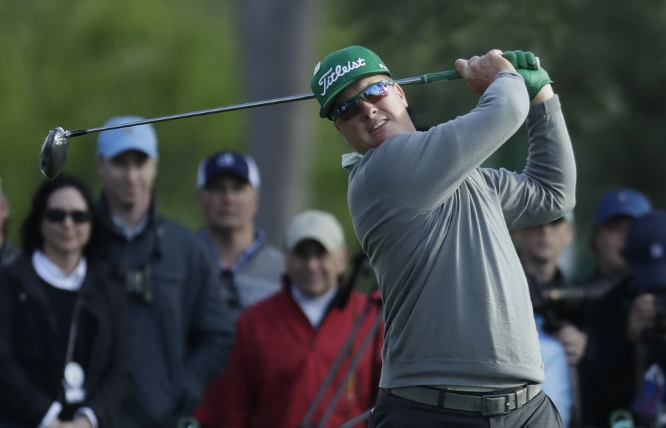 Hoffman drives the ball on the 18th hole on Thursday, April 6. He shot a 7-under 65 to take a four-shot lead after the first round.