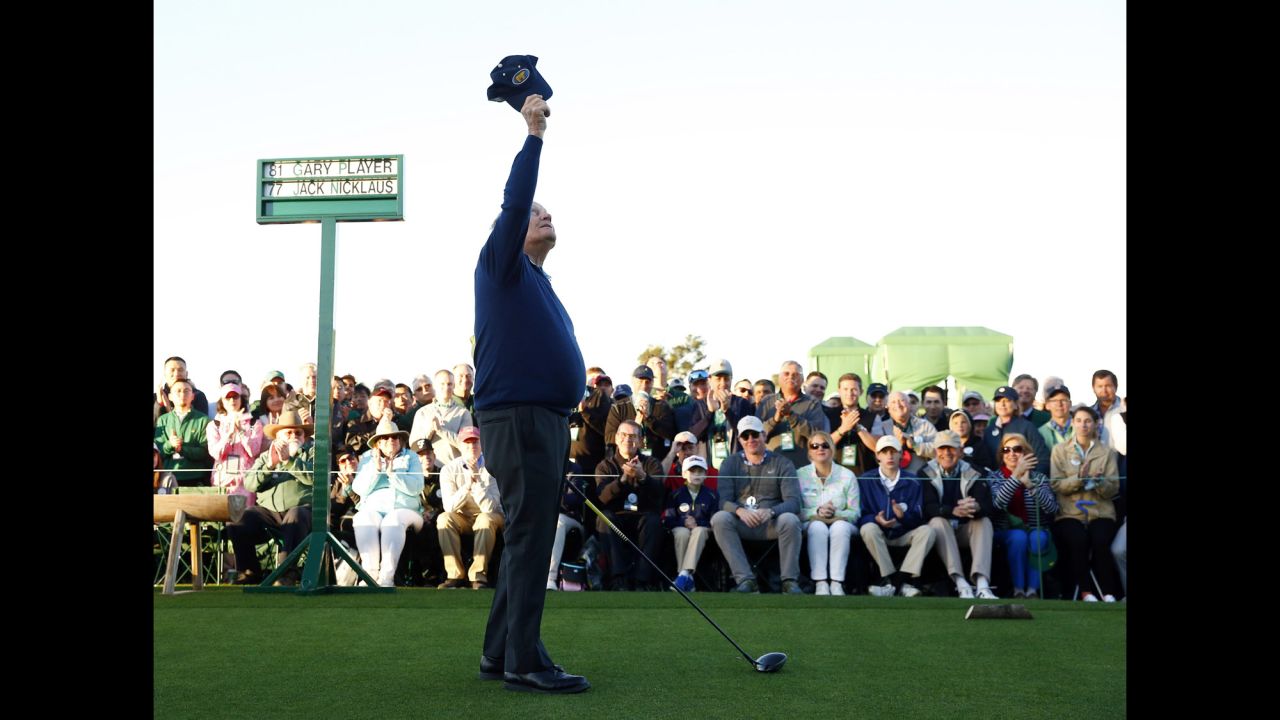 Jack Nicklaus raises his cap to the sky, honoring Palmer before hitting a ceremonial tee shot.