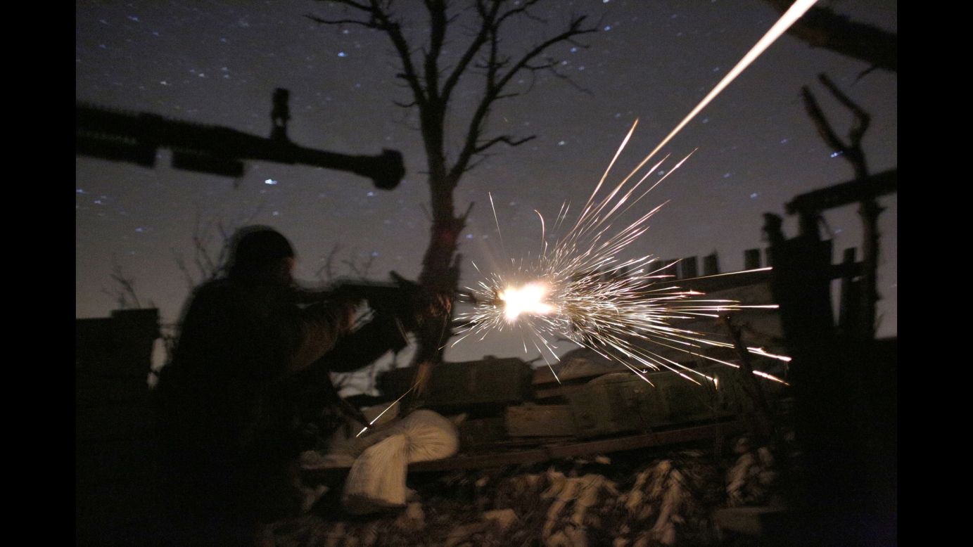 Ukrainian soldiers shoot machine guns as they fight pro-Russian separatists in Avdiivka, Ukraine, on Friday, March 31.