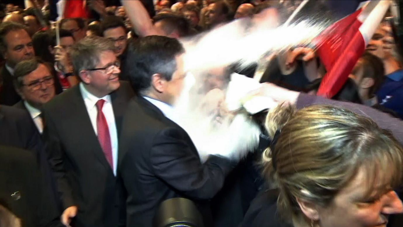 This image, taken from a video recorded on Thursday, April 6, shows a man throwing flour at French presidential candidate Francois Fillon during a rally in Strasbourg, France.