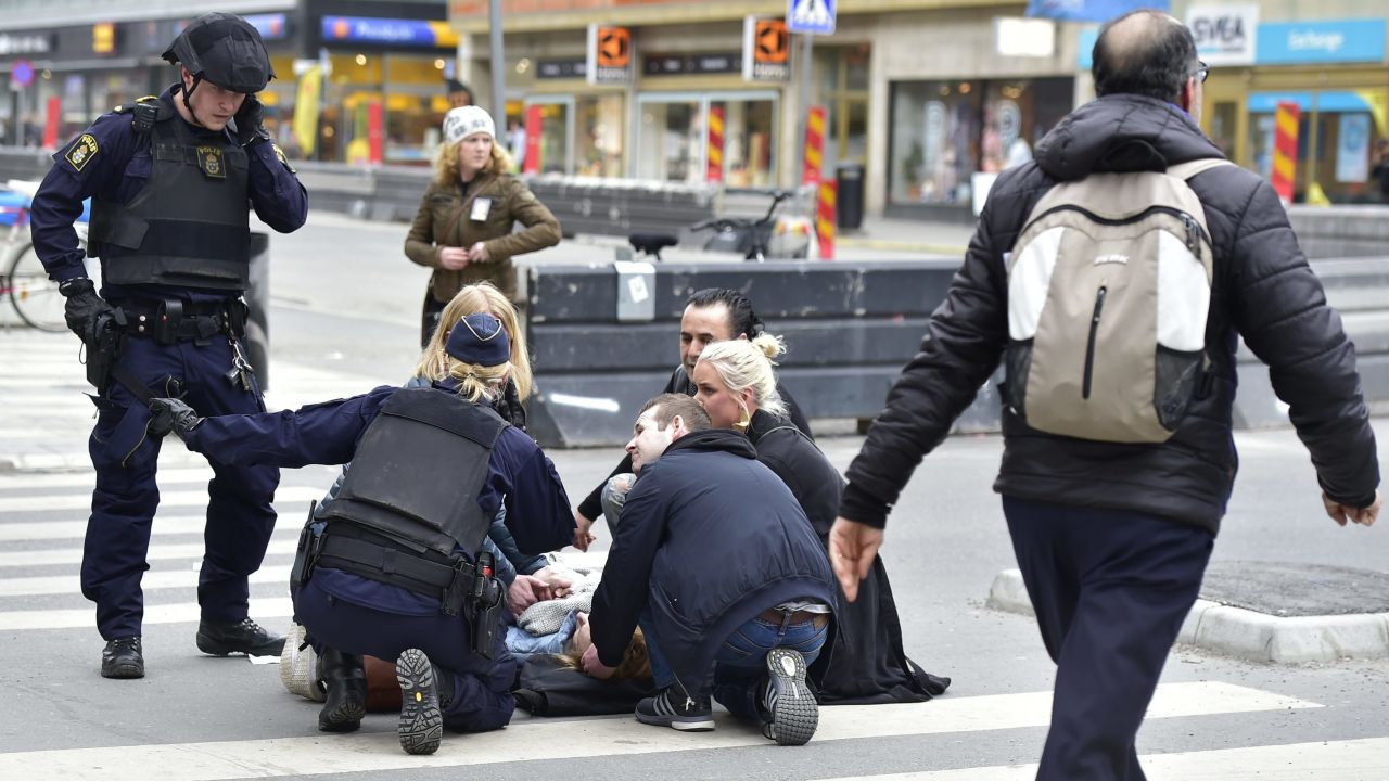 Police attend to people wounded in the Stockholm attack.
