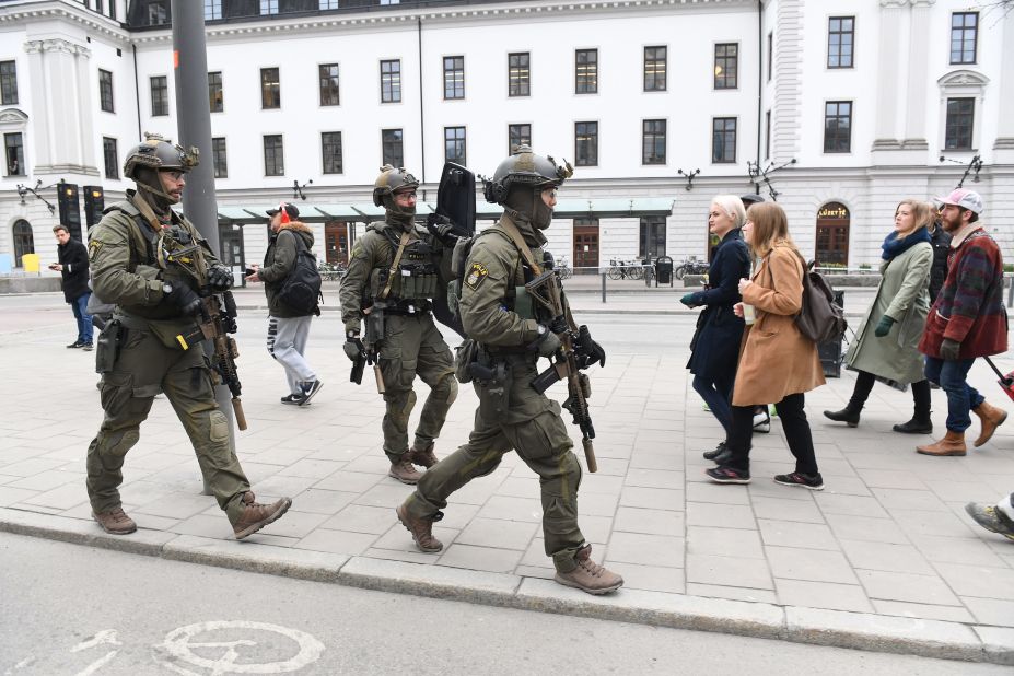Police officers secure the area outside the Stockholm Central train station. Parliament and the Stockholm subway were placed on lockdown.