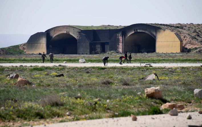People inspect debris near the Shayrat airfield. Syrian President Bashar al-Assad said the United States had carried out an "unjust and unabashed assault" against Syria which "shows nothing but short-sightedness, a narrowness of vision and a blindness to political and military realities."