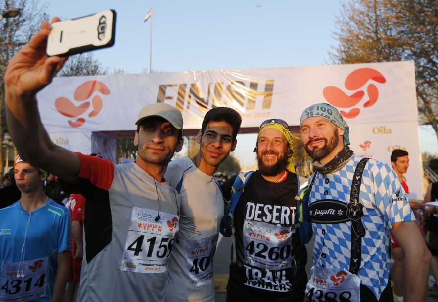 Foreigners and locals pose for pictures at the finish line.