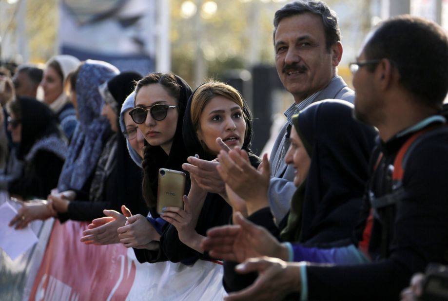 Foreigners and locals watch the first international Tehran marathon at Azadi Square in the Iranian capital.