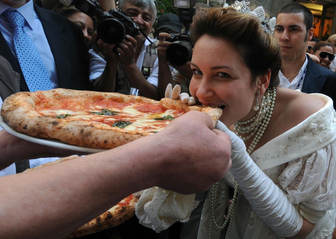 Royal seal: An actress dressed as Queen Margherita of Savoy tastes a Margherita pizza on 120th anniversary of its creation. 