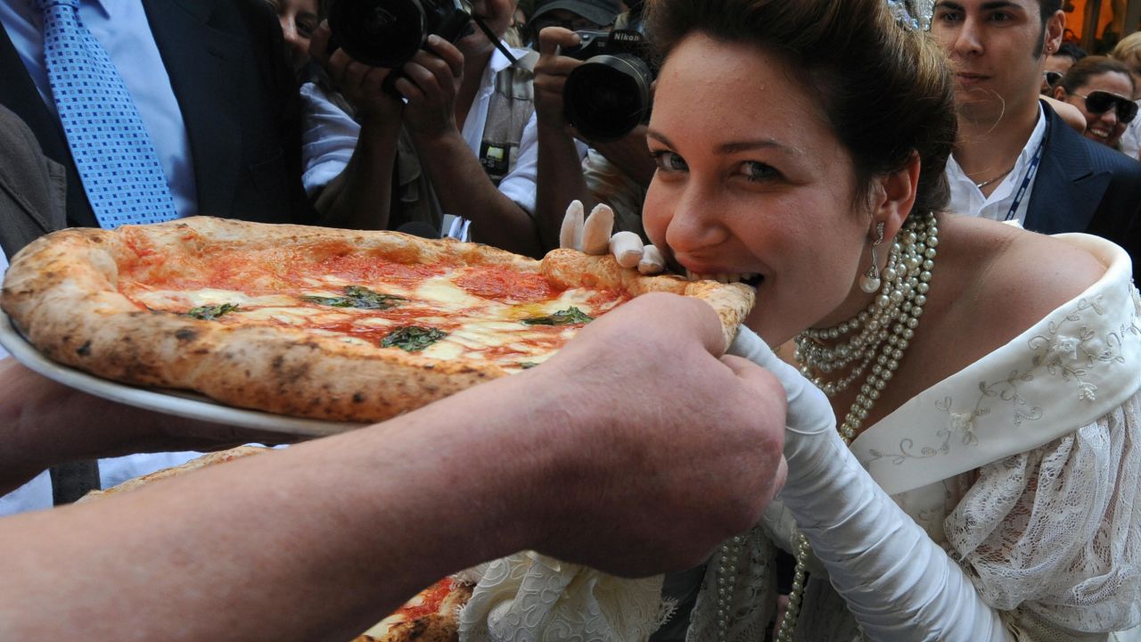 Royal seal: An actress dressed as Queen Margherita of Savoy tastes a Margherita pizza on 120th anniversary of its creation. 