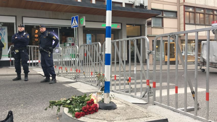 Police officers stand guard Saturday by a cordon surrounding the scene of a truck attack in Stockholm.