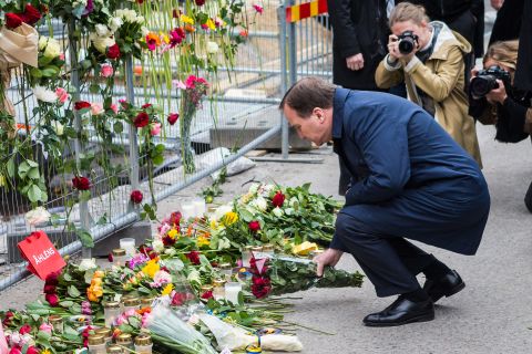 Swedish Prime Minister Stefan Lofven visits the scene of a suspected terror attack on Saturday, April 8. A day earlier, a truck crashed in front of a Stockholm department store, killing four people and injuring more than a dozen others.