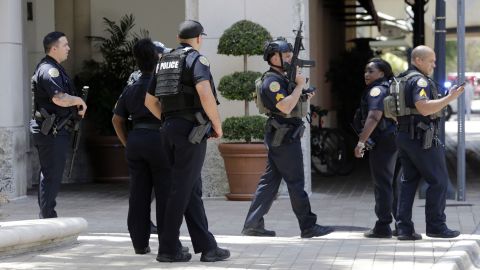 Police gather outside of the Shops at Merrick Park after a shooting.
