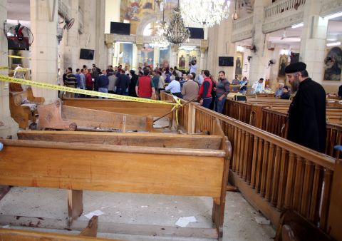 A priest looks at the damage inside the church.
