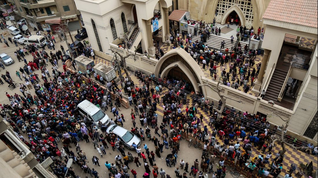 People gather in front of St. George's Church after the bombing.