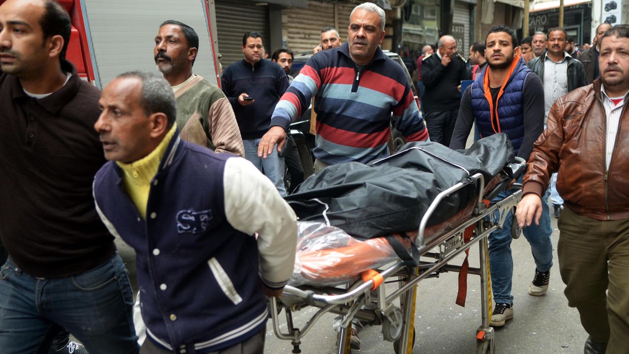 Rescue workers help a victim of the attack in Alexandria.