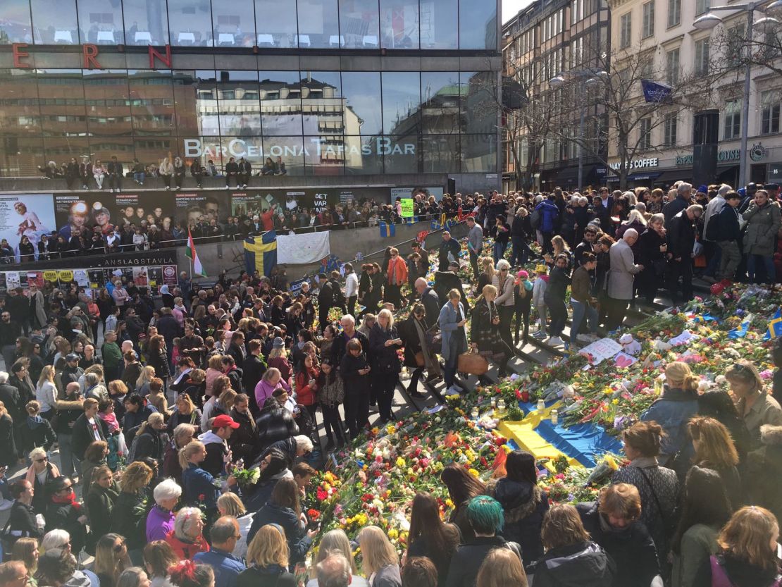 People placed flowers on a Swedish flag in a show of solidarity after the attack.