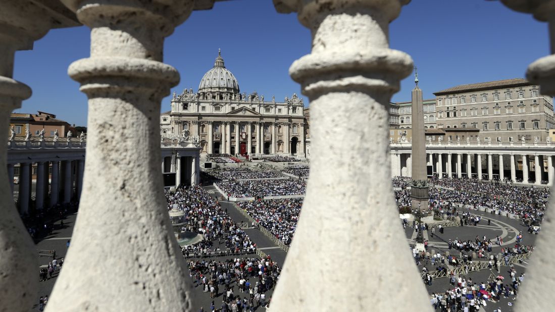 Faithful fill St. Peter's Square as Pope Francis celebrates a Palm Sunday Mass at the Vatican.