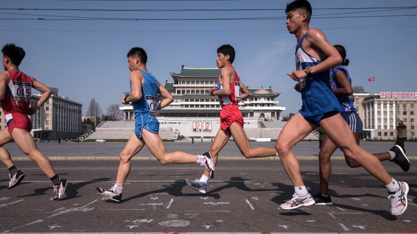 Competitors run through Kim Il-Sung square during the Pyongyang Marathon in Pyongyang on April 9, 2017. 
Hundreds of foreigners lined up in Pyongyang's Kim Il-Sung Stadium on April 9 for the city's annual marathon, the highlight of the tourism calendar in isolated North Korea. / AFP PHOTO / Ed JONES        (Photo credit should read ED JONES/AFP/Getty Images)