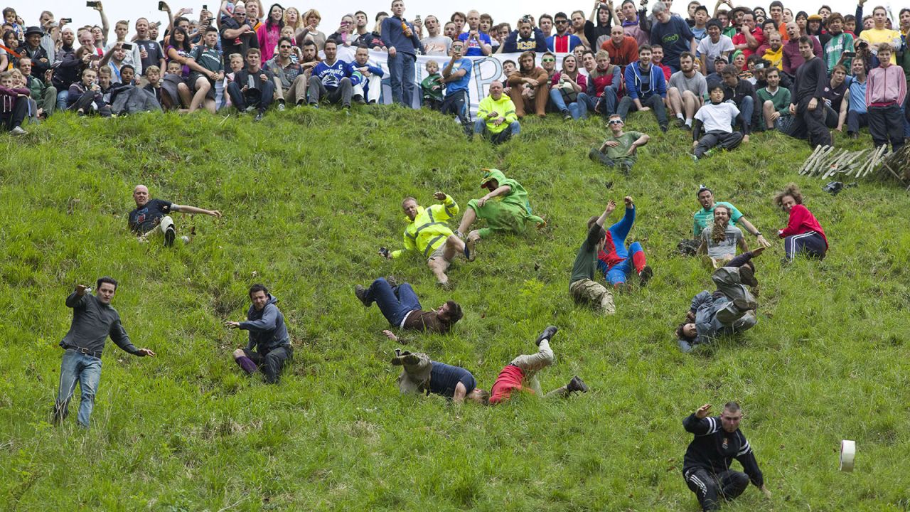 <strong>Cheese-rolling at Coopers Hill in Gloucestershire (England): </strong>Where tumbling down a very steep and rugged hill after a spinning, rolling, bouncing Double Gloucester cheese is serious business. 