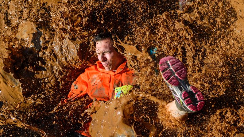 A competitor lands in mud Saturday, April 8, during the Barjot Run obstacle race in Biere, Switzerland.
