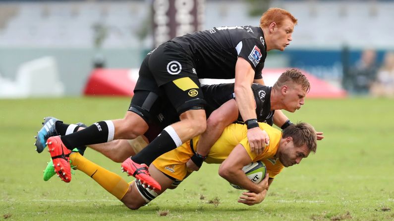Rodrigo Baez is tackled by Philip van der Walt, top, and Jean-Luc du Preez during a Super Rugby match in Durban, South Africa, on Saturday, April 8. Baez plays for the Argentinean club Jaguares. His opponents play for the Sharks, who are based in Durban.