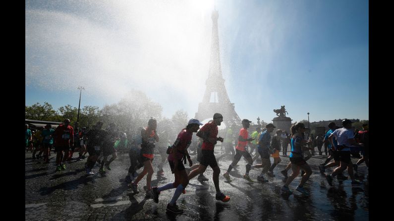 Runners go through a cooling water stream as they compete in the Paris Marathon on Sunday, April 9. <a href="index.php?page=&url=http%3A%2F%2Fwww.cnn.com%2F2017%2F04%2F04%2Fsport%2Fgallery%2Fwhat-a-shot-sports-0404%2Findex.html" target="_blank">See 33 amazing sports photos from last week</a>