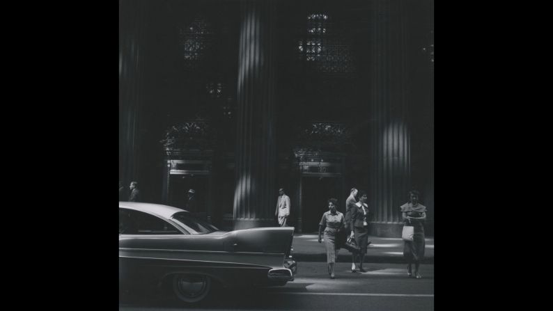 People are photographed on a street in Chicago in 1958.