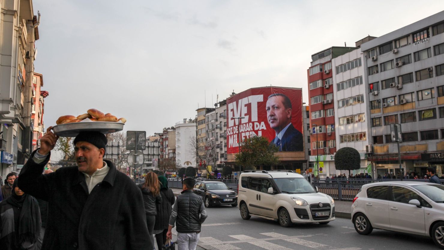 Istanbul residents walk past "Yes" campaign signs in the city center on Saturday, April 8, 2017.  President Tayyip Erdogan's "Yes" campaign slogan reads: "Yes. The people have the freedom to speak and decide." Large banners reading "Evet," or "Yes" can be seen on virtually every corner of the city. 