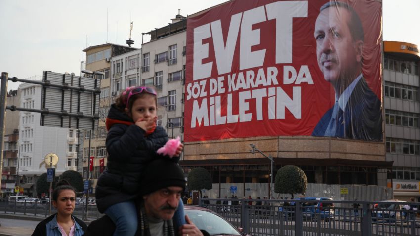 Istanbul residents walk past "Yes" campaign signs in the city center on Saturday, April 8, 2017.  President Tayyip Erdogan's "Yes" campaign slogan reads: "Yes. The people have the freedom to speak and decide." Large banners reading "Evet," or "Yes" can be seen on virtually every corner of the city. 