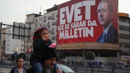 Istanbul residents walk past "Yes" campaign signs in the city center on Saturday, April 8, 2017.  President Tayyip Erdogan's "Yes" campaign slogan reads: "Yes. The people have the freedom to speak and decide." Large banners reading "Evet," or "Yes" can be seen on virtually every corner of the city.