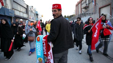 A vendor selling scarves with President Tayyip Erdogan's name on them at a rally for the "yes" vote in Istanbul's Yenikapi Square on Saturday, April 8, 2017. 