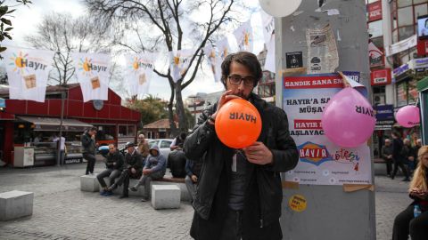 A supporter from Turkey's pro-Kurdish political opposition party, the Peoples' Democratic Party (HDP), blows up a "Hayir" or "No" balloon at party tent in the middle of Istanbul on Sunday, April 9, 2017.