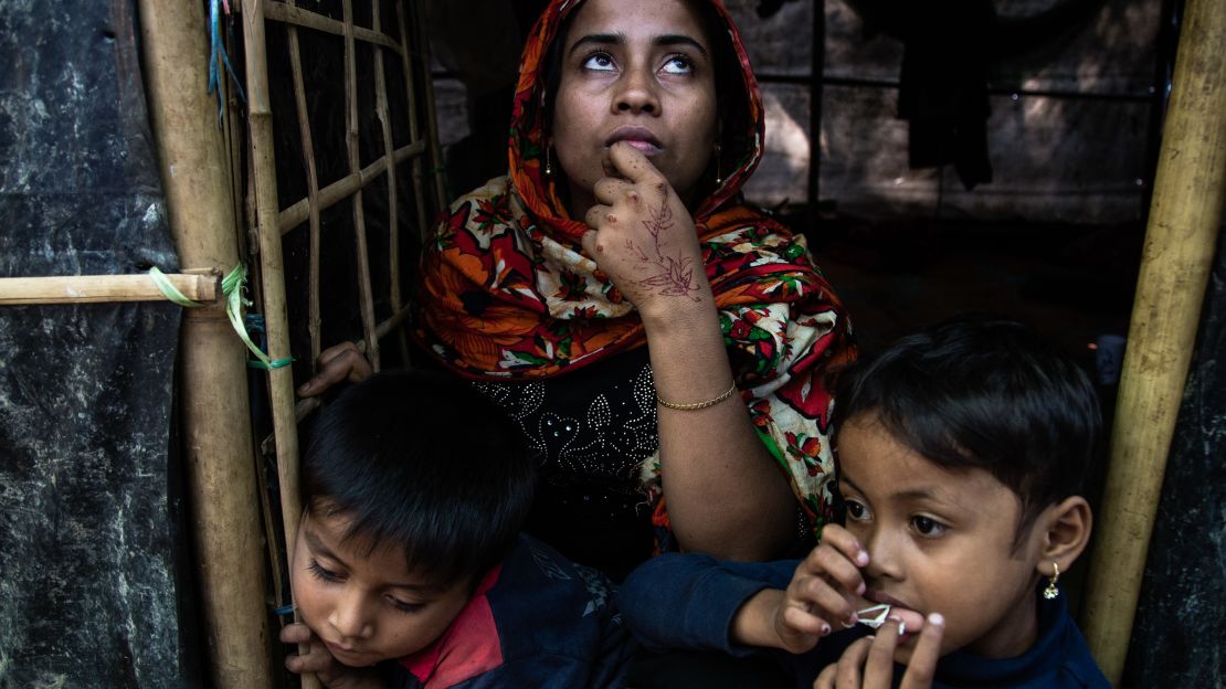 Mohsena, 22, is seen in front of her shelter with her two children.