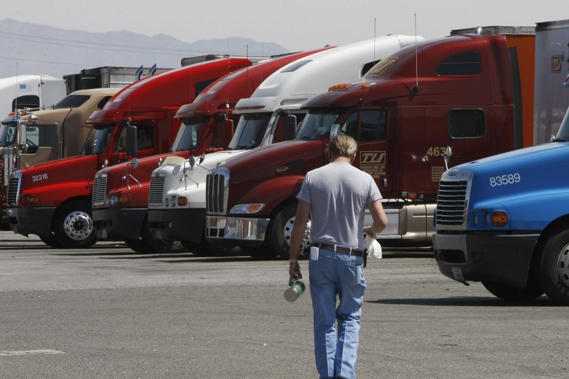 A trucker walks back to his truck at a truck stop in Oak Hills, California.