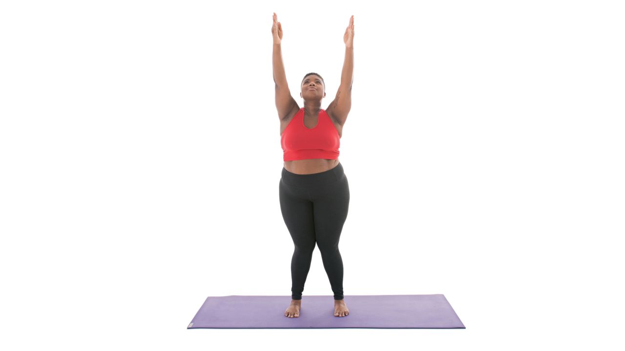 <strong>Upward salute: Urdhva Hastasana</strong> Before moving into upward salute, begin in mountain pose. "Extend through your fingertips. Relax the sides of your neck. Lengthen through the sides of your body. Distribute weight evenly through your feet," Stanley says.