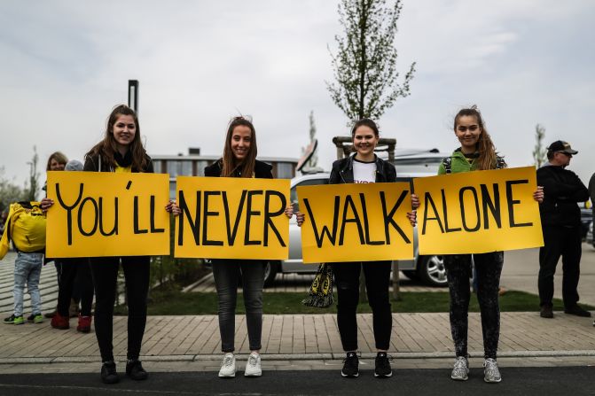 Outside Dortmund's training ground Wednesday, four fans held a sign in support of their team which read "You'll Never Walk Alone" -- which is the title of the club's anthem.