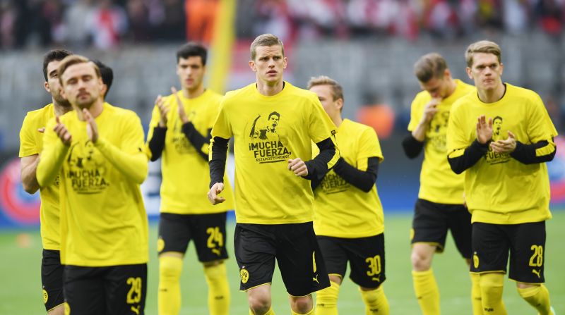 Showing support. Dortmund´s players wore T-shirts with 'Mucha Fuerza' (A lot of strength) and a picture of teammate Marc Bartra -- injured in the bomb attack on Dortmund's team bus -- on the front. 